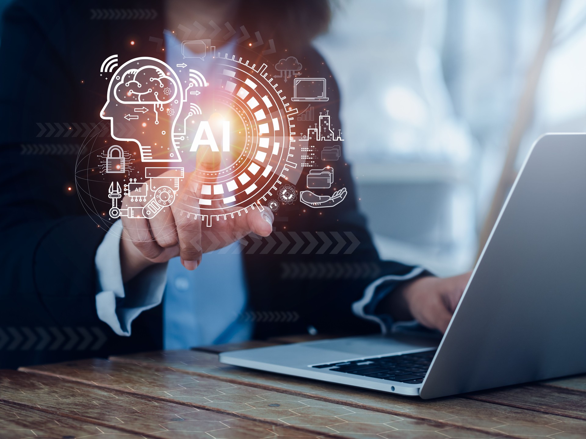 Artificial Intelligence concept (AI). Futuristic virtual graphics of digital brain circuit, management processes systems, machines elements technology pointing by hand while using laptop computer.